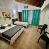 Camas habitación triple con terraza Loto del viento